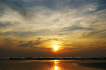 dramatic clouds. Sunset on a tropical island combined with sea and clouds in a dramatic sky