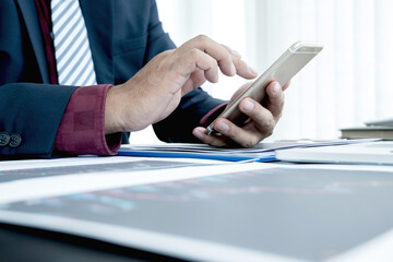 Hand of businessmen are planning business investments related to shares By analyzing and...