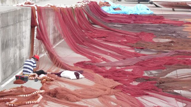 fisherman working on fishing net slow motion 4k