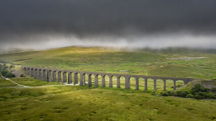 Ribblehead Viaduct North Yorkshire, train line from Settle to Carlise. drone photograph of the viaduct and countryside in low cloud. 