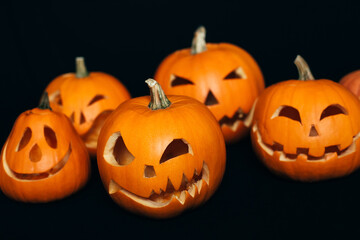 orange pumpkins with carved faces for Halloween celebration