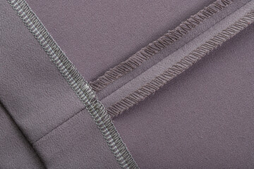 details of clothing, the seam is made on a sewing machine, the sections are processed with threads - obrazy, fototapety, plakaty