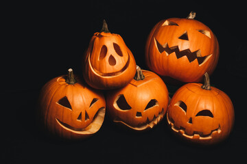 holiday card with Halloween pumpkins with carved faces to decorate