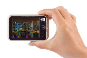 Hand with camera and Singapore city skyline (my photo)