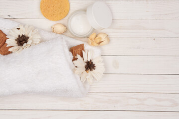 Fototapeta na wymiar White towel cosmetics bathroom accessories wooden background scenery
