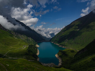Fototapeta na wymiar Scenic view on Wasserfallboden See near Kaprun, Austria, Europe. National park Hohe Tauern. Charming lake with amazing deep colorful water and wild clouds on sky.