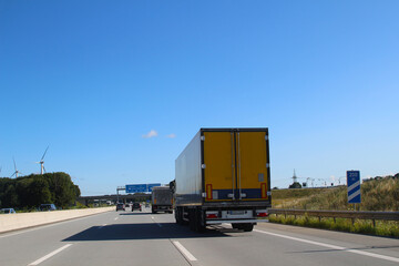 Cars and trucks on the highway and wind turbines at roadside (A7, Schleswig-Holstein, Germany)