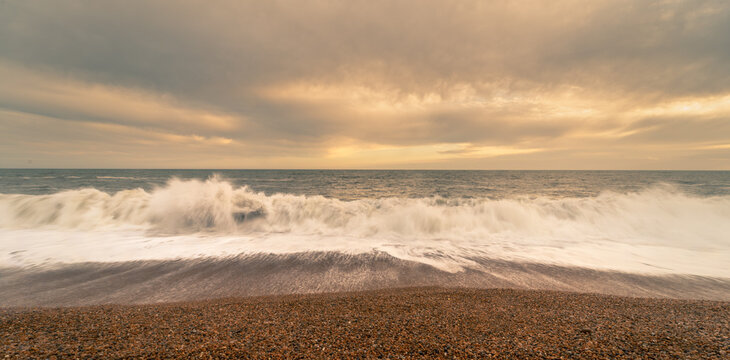 Sunset beach landscape photo with the crashing waves on Chisel Beach on the English south coast.  This is also known as the Jurassic Coastline.