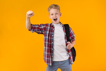 Little guy celebrating over yellow studio background