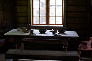 Medieval simple farmers dining table by the window with natural sunlight steaming in.