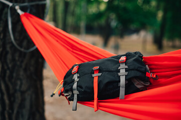 Travel waist bag lies on a magic hammock in the woods. Tourist gear concept. Subject photo of a...