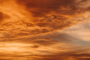 Naklejka na ściany i meble Orange clouds in the sky during the sunset