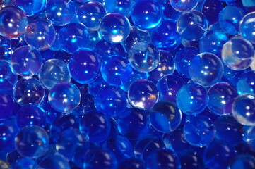 Blue jelly beads from a room fragrance device. Close-up image. abstract background with bubbles.