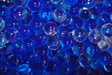 Blue jelly beads from a room fragrance device. Close-up image. abstract background with bubbles.