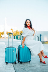 Travelling woman with luggage on her way to the airport.