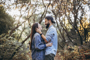stylish hipster couple in love dressed in denim walks in the autumn park