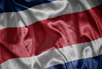 colorful shining big national flag of costa rica on a silky texture.
