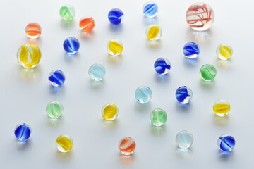 Colorful glass marbles on white background.