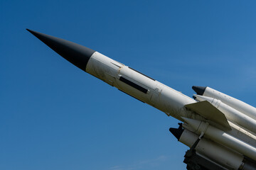 Old missile or rocket on its launch ramp against a clear blue sky