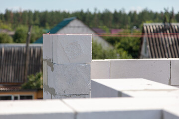 Construction of the walls of the house from foam concrete bricks.