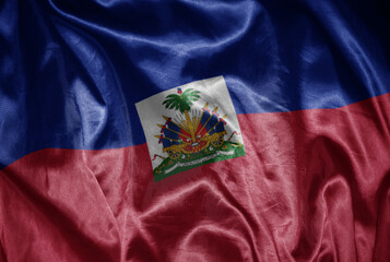 colorful shining big national flag of haiti on a silky texture.