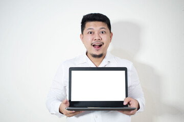 A young businessman in a white shirt holding a laptop
In a white background