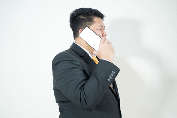 A business man wearing a suit and yellow tie
Holding a white blank screen phone
In a white background