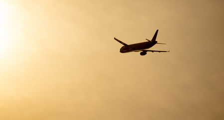Silhouette of an airplane at sunset.