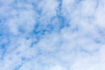 Obraz premium White clouds on a blue sky as background