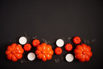 Halloween background, orange decorative plastic pumpkin black paper bat black cardboard Thanksgiving greeting card