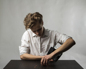 Fototapeta premium Young man in white and wallet with twenty Euro.
