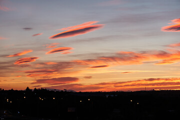 Fototapeta premium The last rays of the sun cast their reddish and orange colors into the clouds. Madrid. Spain