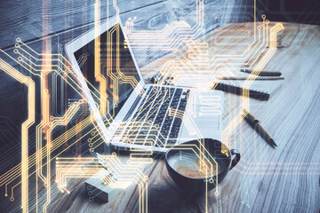 Obraz premium Computer on desktop in office with technology theme hologram. Double exposure. Tech concept.