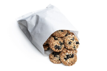 Healthy protein granola crackers with raisins and nuts in paper bag isolated on white