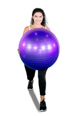 Unknown woman exercise with a yoga ball on studio