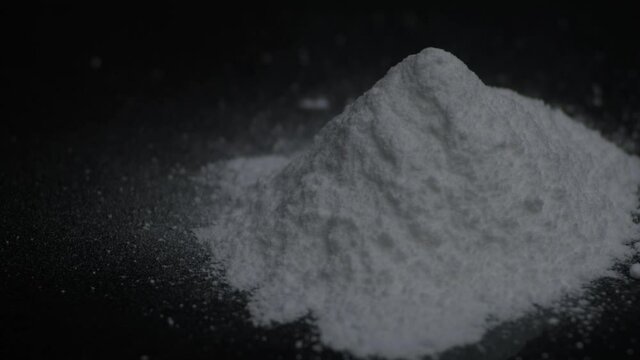 Cocaine powder rotating on a black background. 