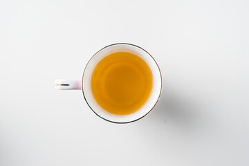 Top view of cup of hot tea on white background
