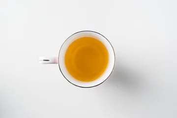 Deurstickers Top view of cup of hot tea on white background © voyata