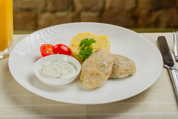 Hot cutlets with mashed potatoes and sauce.