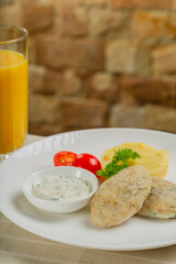Hot cutlets with mashed potatoes and sauce.