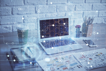 Double exposure of desktop computer and technology theme hologram. Concept of software development.