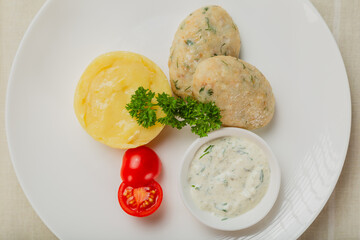 Hot cutlets with mashed potatoes and sauce.