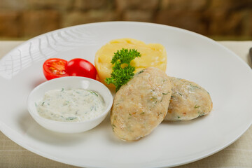 Hot cutlets with mashed potatoes and sauce.