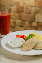 Hot cutlets with mashed potatoes and sauce.