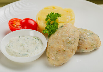 Hot cutlets with mashed potatoes and sauce.