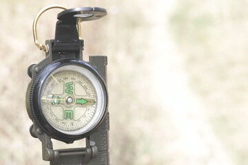Old classic navigation compass on road background as symbol of tourism with compass, travel with...