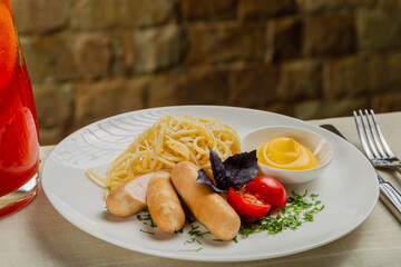 Fresh sausages with pasta and cheese sauce.