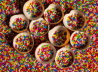 Broken brown eggshells and bright foam balls