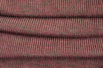 Pleats on fabric, knitted material of brown color, folds