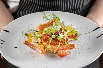 Prawn salad. Healthy Shrimp Salad with mixed greens and tomatoes, the food glows in a beautiful backlight.